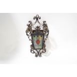 A Victorian ornate wrought iron hanging lantern, with stained glass panels,