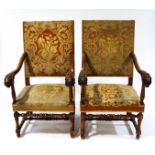 A pair of Victorian armchairs in the 17th century style, with carved lion's head arms,