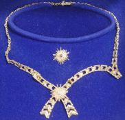 A 9 carat gold collar, London 1977, with two detachable central starburst motifs,