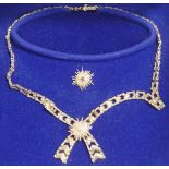 A 9 carat gold collar, London 1977, with two detachable central starburst motifs,