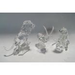 Three Swarovski Crystal animals: Lion on a rock, Seated Leopard (one eye missing) and an Ibex,