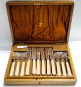 A Mappin & Webb set of twelve fish knives and forks in an oak case