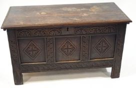 An 18th century oak coffer with carved triple panelled front,
