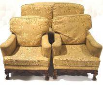 An early 20th century suite comprising a two seat sofa and two matching armchairs,