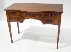 A Sheraton style mahogany sideboard of serpentine form with boxwood stringing,