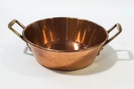 A 19th Century copper jam pan with two brass handles,