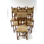 A set of six French walnut dining chairs with lionhead finials,