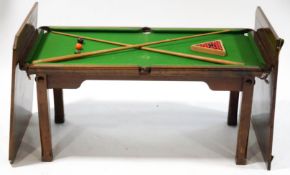 An early 20th century quarter size billiards/dining table, oak frame with slate base,