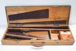 An early 20th century mahogany gun case with key and cleaning materials inside,