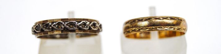 A 9 carat gold wedding ring; with a synthetic set eternity ring,
