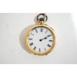 A fob watch, stamped '18k', with a white enamel dial, black Roman numerals and hands,