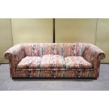 An exceptionally large modern sofa, upholstered in geometric Ikat style fabric,