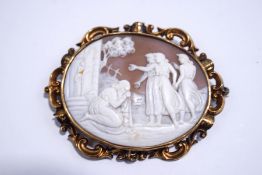 A Victorian shell cameo brooch, to an unmarked gold scroll frame, 7.6 cm long, 25.