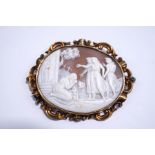 A Victorian shell cameo brooch, to an unmarked gold scroll frame, 7.6 cm long, 25.