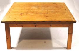 A large rectangular pine table with rectangular legs,