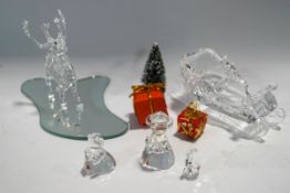 A Swarovski Crystal Christmas sleigh and reindeer, with presents and tree accessories,