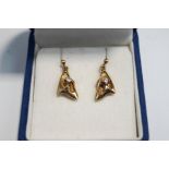 A pair of diamond drop earrings, unmarked, the triangular abstract mount set with a brilliant cut,