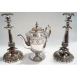 A pair of Sheffield plated candlesticks, with vine, foliage and scroll decoration, shaped bases,