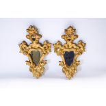 A pair of small giltwood mirrors, of cartouche shape,