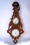A carved oak combination clock and barometer, the latter signed N.
