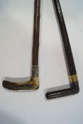 A walking stick with horn handle and silver collar,
