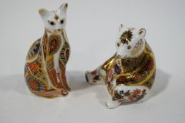 Two Royal Crown Derby paperweights, a seated bear and a cat, gold coloured stoppers,