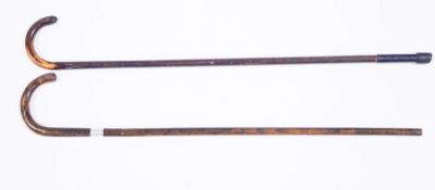 A pair of walking sticks with silver bands (rubbed)
