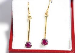 A pair of ruby drop earrings, unmarked, the collet set round cuts to a bar suspension,