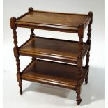 An oak three tier trolley with barley twist supports,