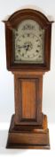 A miniature oak cased long case clock with silvered arched dial, 30.