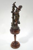 After Moreau, a large spelter figure of a French maiden, standing next to a column,