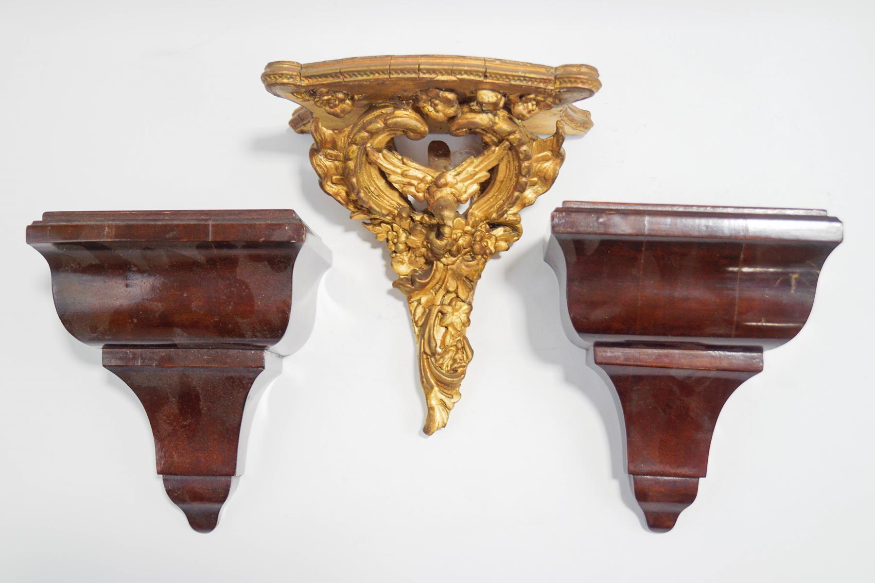 A small giltwood wall bracket, carved as a bird among a 'C' scroll and swags, 20cm high,