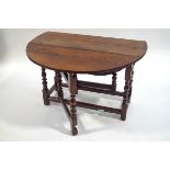 A late 17th Century oak oval gate leg table on turned legs linked by stretchers, 67.