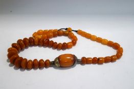 A string of amber coloured eastern beads