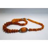 A string of amber coloured eastern beads