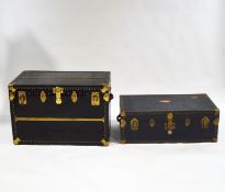 Two mid-20th century brass bound travelling trunks,