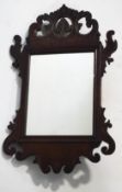 A small Chippendale style mahogany fret framed wall mirror,