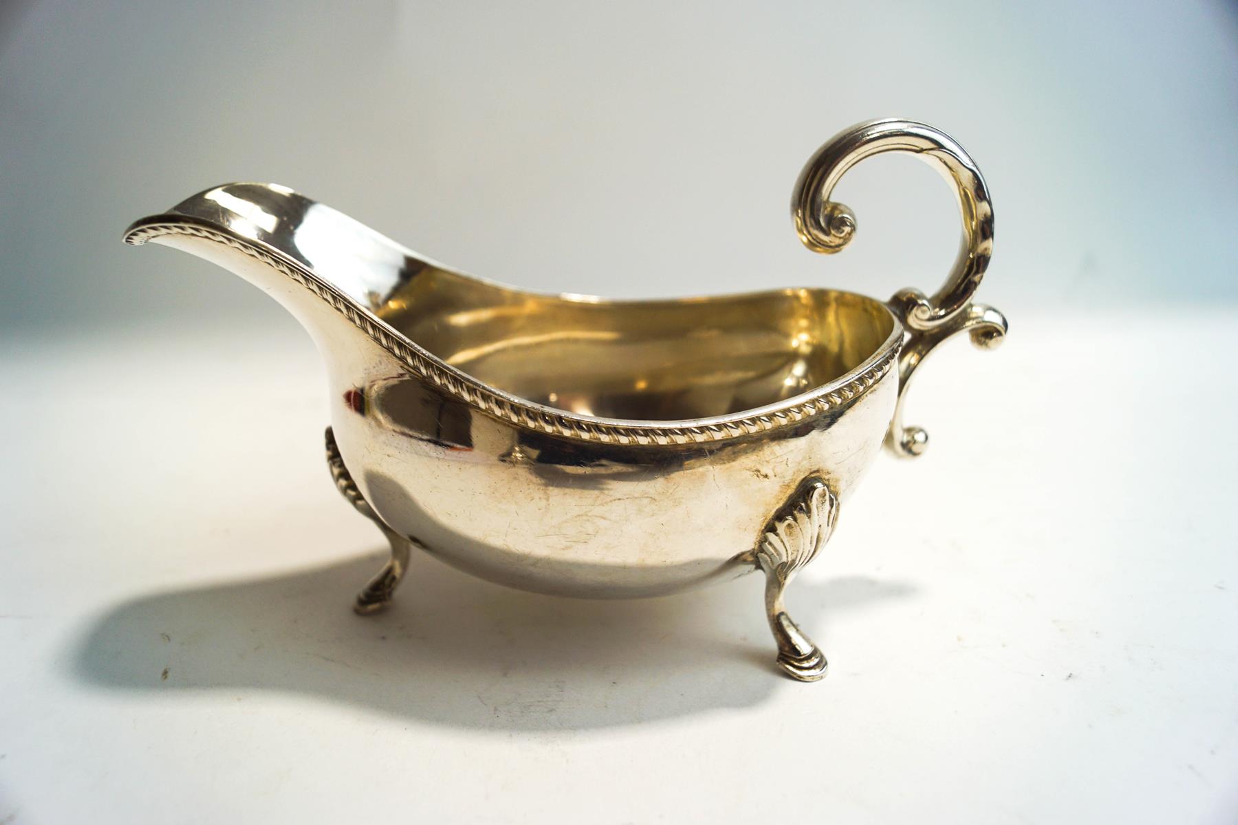 A silver sauce boat, maker's mark E.