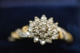 A 9 carat gold nineteen stone diamond cluster ring, the diamonds totalling approximately 0.