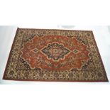 A large modern Persian style carpet, with central medallion upon a terracotta ground,