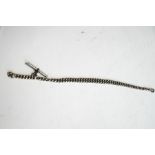 A silver watch chain, of graduated curb links, 34 cm long,