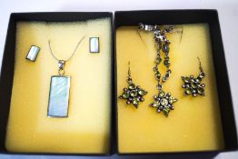 A peridot pendant and earring set; with another set of stained mother of pearl;