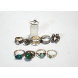 A collection of ten silver rings, some stone set,
