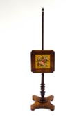 A William IV rosewood pole screen, with woolwork panel of a bouquet of flowers, upon a triform base,