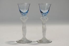 A pair of Bacchantes glass tots, circa 1920, modelled as nude maidens,