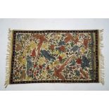 A crewelwork wall hanging of exotic birds with branches,
