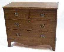 A George III mahogany chest of two short and two long drawers with shaped apron,