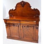 A Victorian mahogany sideboard with raised 'C' scroll back, above two drawers and cupboard base,