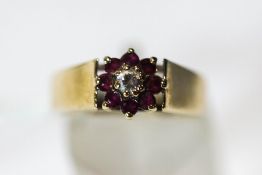 A 9 carat gold cubic zirconia and ruby cluster ring, finger size M,