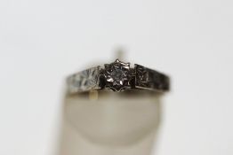 An 18 carat white gold single stone diamond ring, with an illusion set single cut, finger size N1/2,